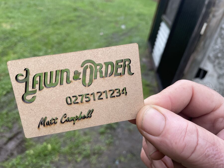 Lawn & Order business card with phone number 027 512 1234